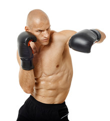 Very fit kickboxer punching on white