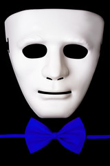 White mask and  bow tie isolated on black background