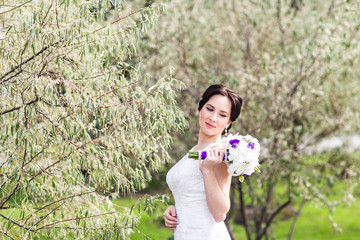 Beautiful bride in wedding dress and bridal bouquet