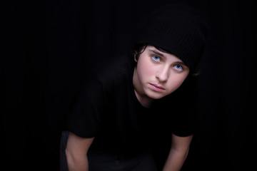 Portrait of a teen boy in a black cap