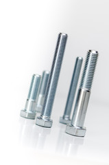 Arranged metal bolts on white background