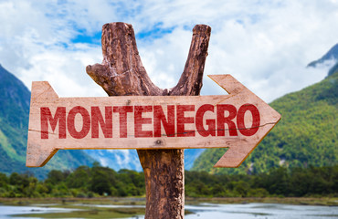 Montenegro wooden sign with mountains background
