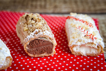 Chocolate and icing topping eclairs with chocolate and vanilla c