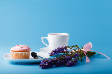 Colorful muffin on saucer with flowers
