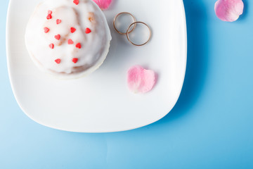 Colorful muffin on saucer with flower petal and message 
