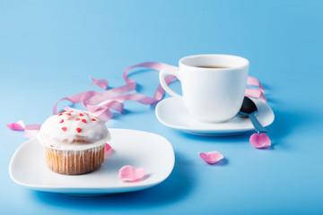 Colorful muffin on saucer with flower petal and message 