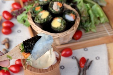 Vegetable salad wrapped with seaweed into spring rolls.