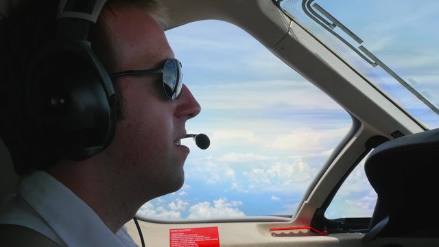 Jet Pilot in Cockpit Talking on Radio Headset