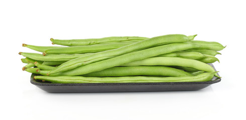 Pile of green french beans on black plastic plate