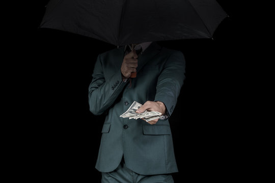 Man corruption, giving money, hiding behind an umbrella