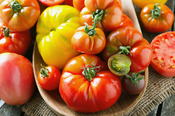 assorted tomatoes on wooden surface