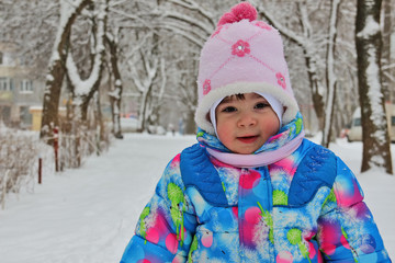 Small child against winter snow landscape