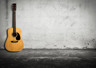 Fototapeta na wymiar Acoustic guitar against old wall