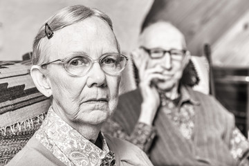 Toned Image of Elderly Couple Sitting in Living Room