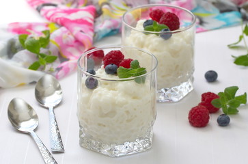 Rice pudding with berries in glasses