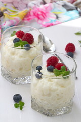 Rice pudding with berries in glasses