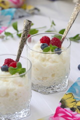 Rice pudding with berries in glasses