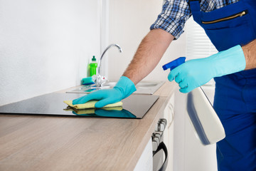 Worker Cleaning Electric Hob