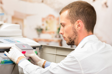 closeup shot young technician refilling toner in photocopier machine