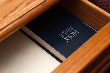 Holy Bible book in a open drawer upside down