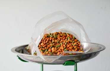 dog food in plastic bag on weighting scale tray