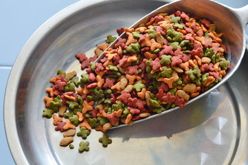 cat food in scoop on weighting scale tray