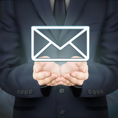 businessman holding e-mail icon