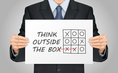 businessman holding think outside the box poster