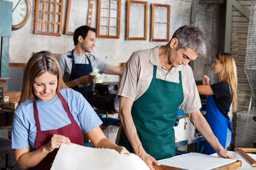 Workers Manufacturing Papers In Factory