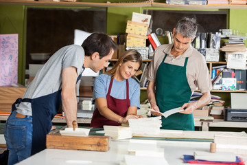 Workers Working Together In Paper Factory