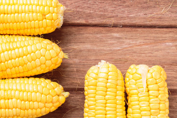 Fresh sweet corn on wooden background