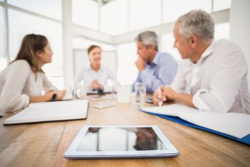 Fototapeta premium Tablet in front of talking business people
