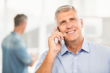 Smiling businessman on the phone