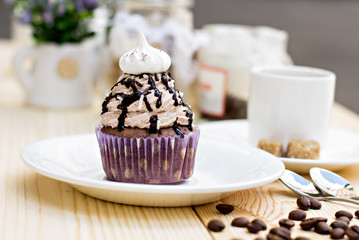 Chocolate Cupcake with chocolate frosting on the table