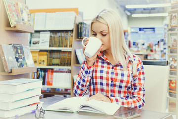 Portrait of a young student using her laptop in a library