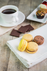 macaroons with coffee on wooden table