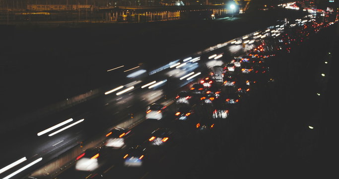 Apocalyptic Highway. Timelapse of busy fast traffic on an highway at night, with traffic light trails