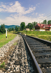 Fototapeta na wymiar railway through a village in Carpathians