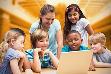Composite image of cute pupils using tablet computer in library