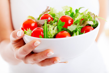 Salad bowl in woman hands