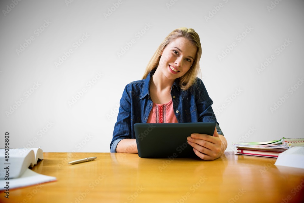 Poster composite image of student studying in the library with tablet