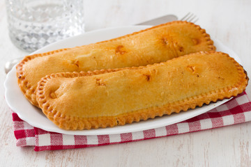 typical portuguese cookies on plate on white background and glass of water