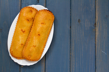 typical portuguese cookies on plate on blue wooden background