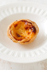 portuguese egg cookie on white dish on white background
