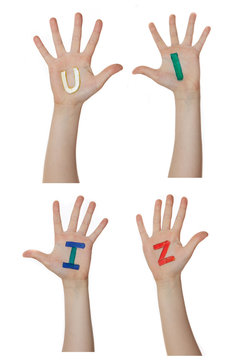 Alphabet (letters) painted on children hands.  Rises up hands. 