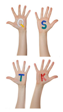 Alphabet (letters) painted on children hands.  Rises up hands. 