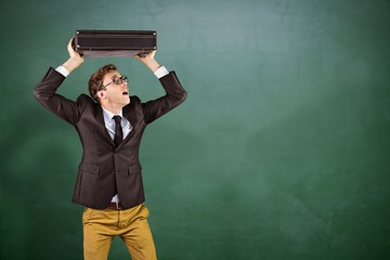 Composite image of young geeky businessman holding briefcase