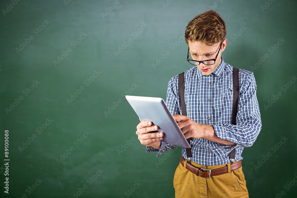 Canvas Prints Composite image of geeky businessman using his tablet pc