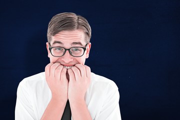 Composite image of geeky businessman looking nervously at camera
