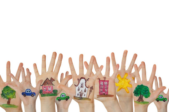 Abstract street made of painted symbols. Houses, trees, cars painted on children hands raised up. 